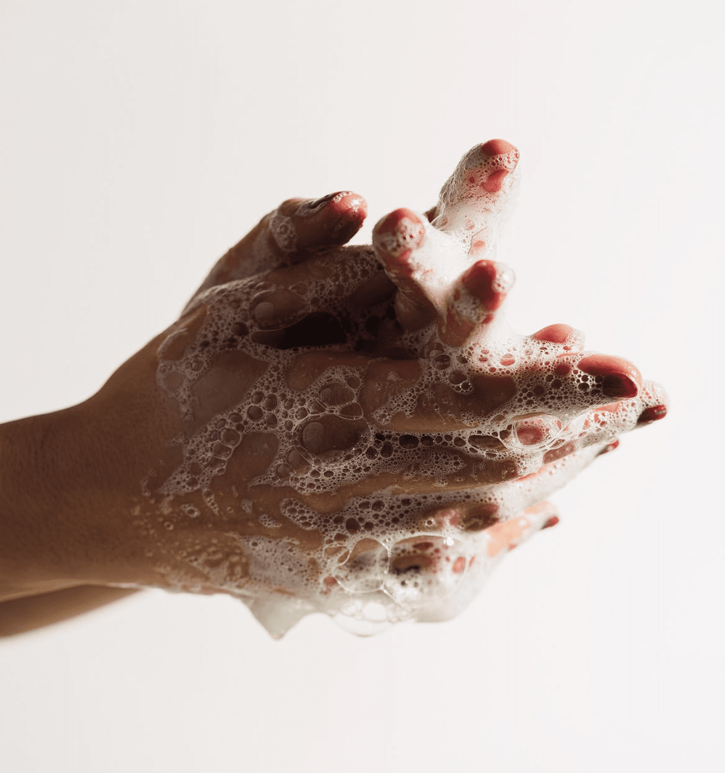 Hands being washed with soap — the core mission of Heads Up Hygiene