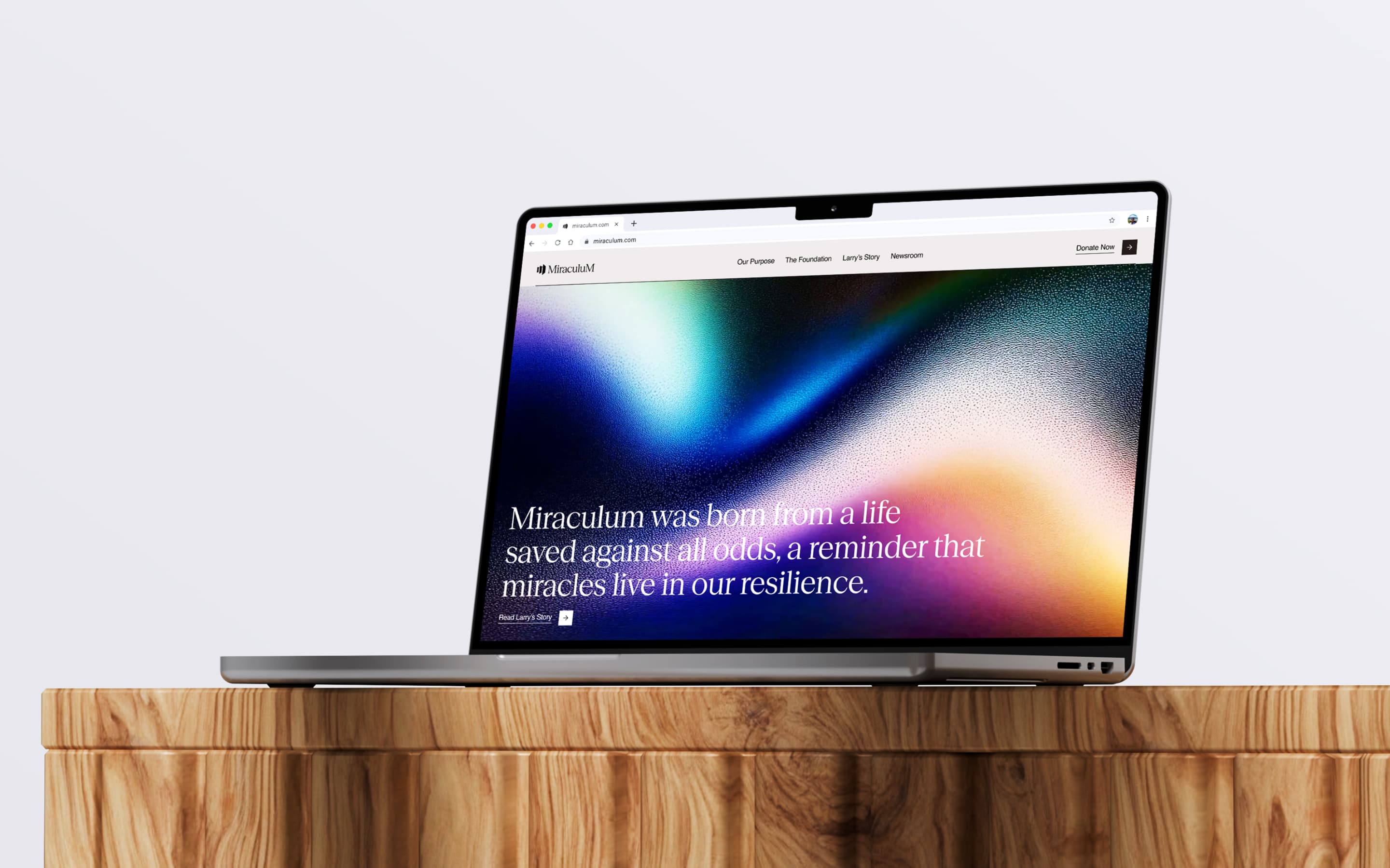 Miraculum website shown on a laptop